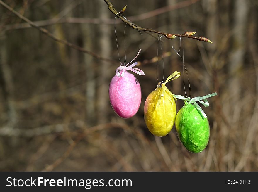 Tree easter egg, pink yellow an green on a branch