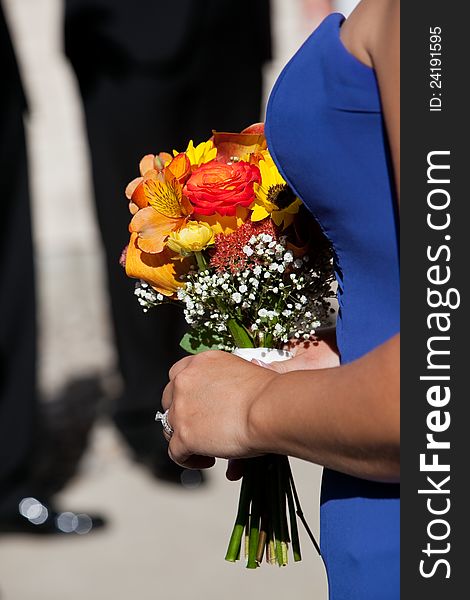 A bridesmaid holding a bouquet of flowers at a wedding