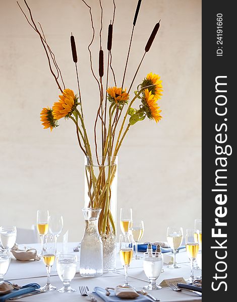 A large wedding table centerpiece with a sunflower bouquet