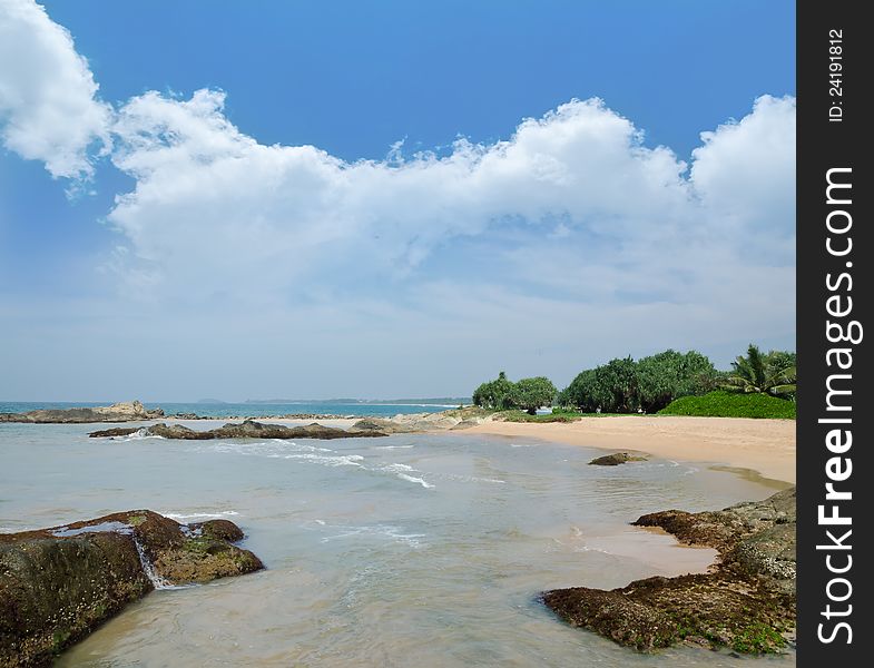 Stones in the waves on ocean coast