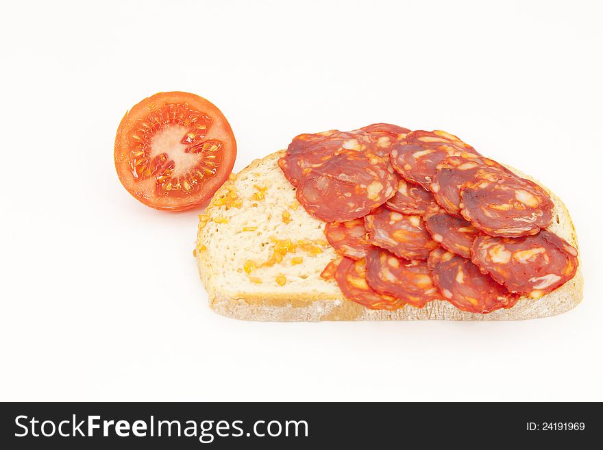 Bread with tomato and sausage ??Iberico on a white background