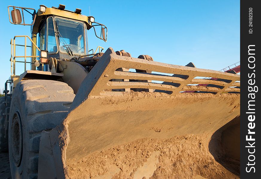 Earth moving digger in a gravel pit.