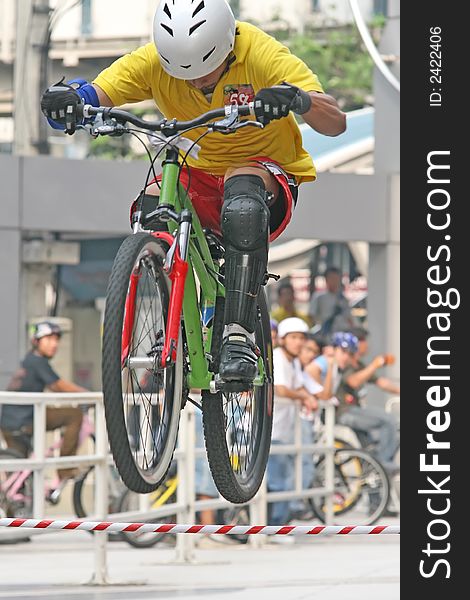 Mountain biker jumps an obstacle during a competition. Mountain biker jumps an obstacle during a competition