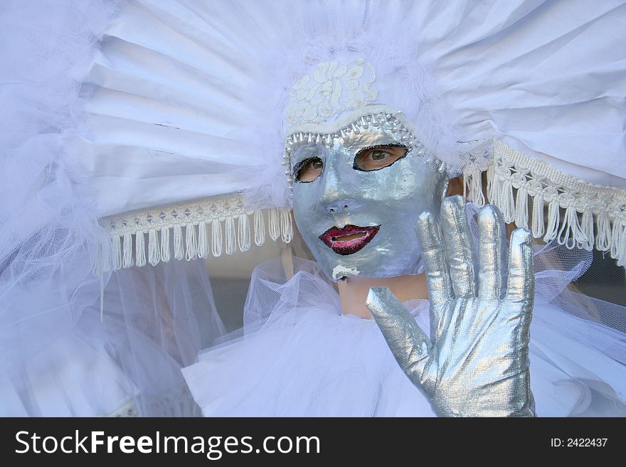 Models dresed in venetian masks are ready for carnival walk