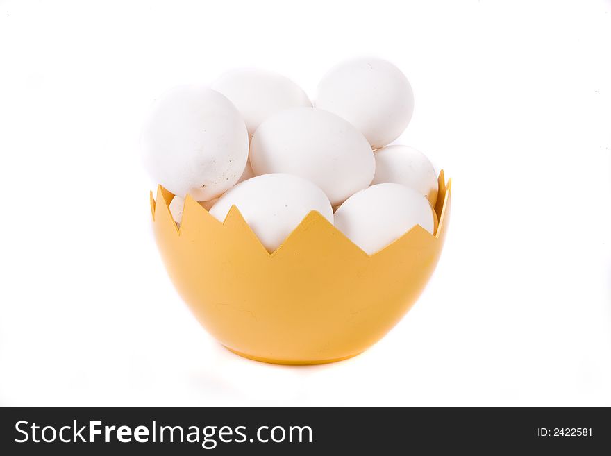 Many eggs in yellow eggshell on white background