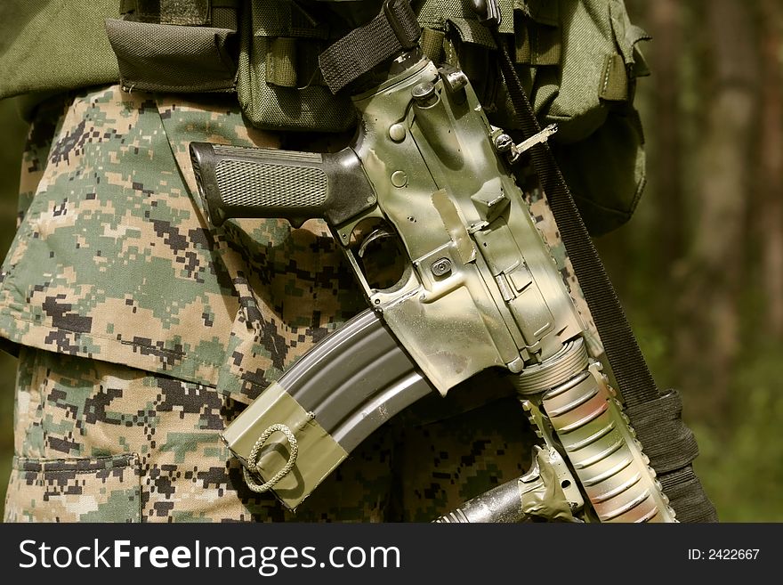 Detail of an armed U.S. Marine corps soldier.