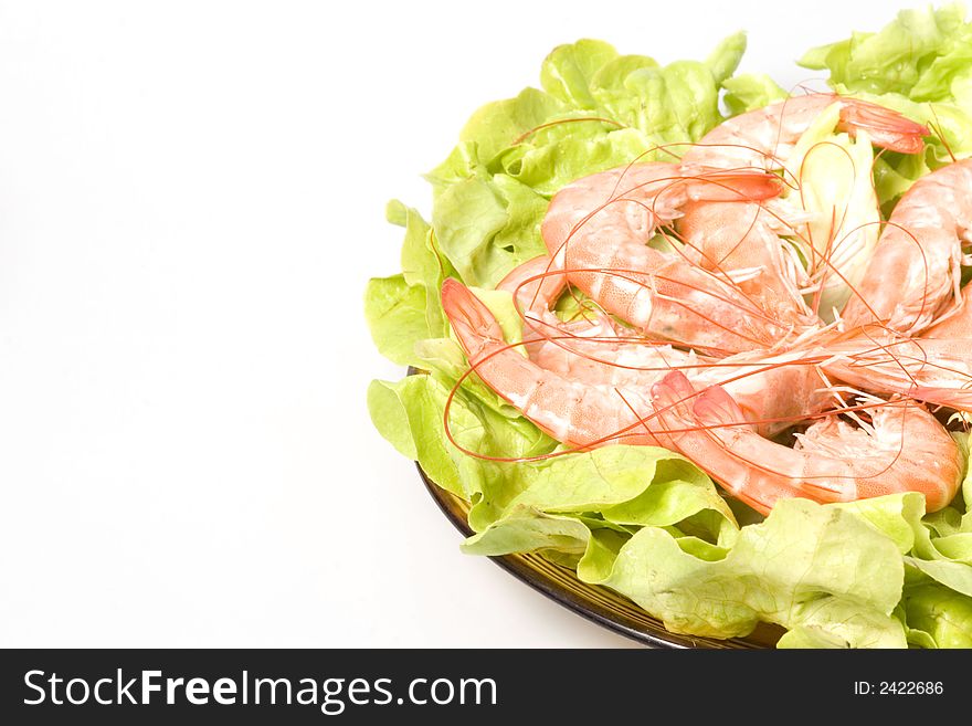 Closeup of  shrimps on plate served with green romano salad are ready to eat