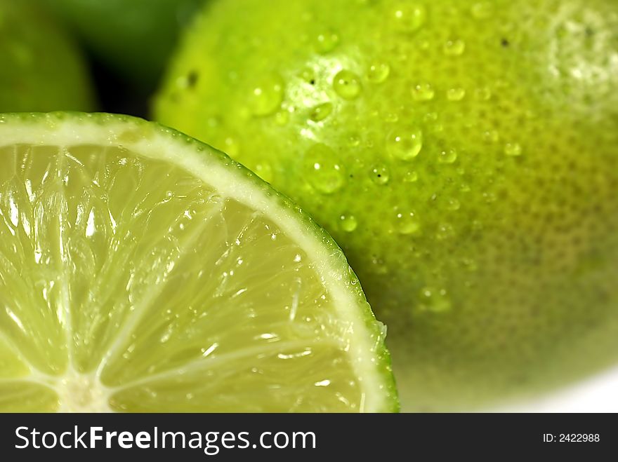 Lime with water drops on white background. Lime with water drops on white background