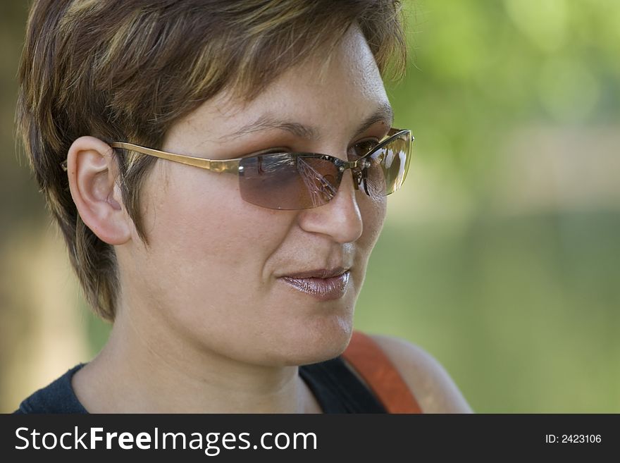 Woman with sunglasses portrait over green background