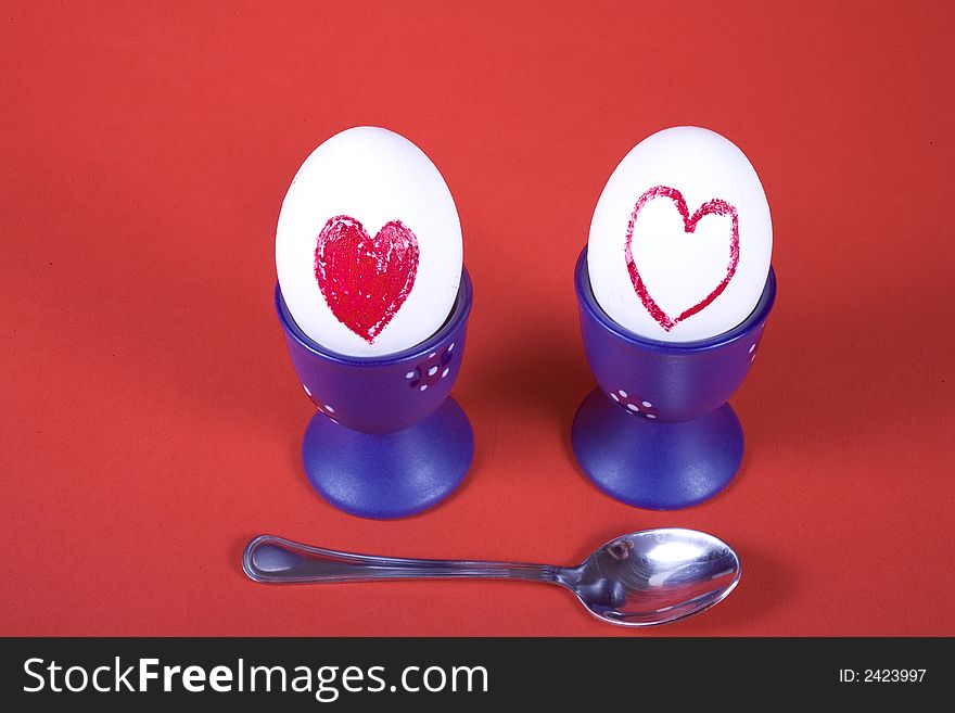Two eggs in heart on red background