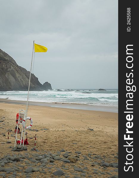 Yellow flag warning at a lifeguard station on a beach in southern Portugal