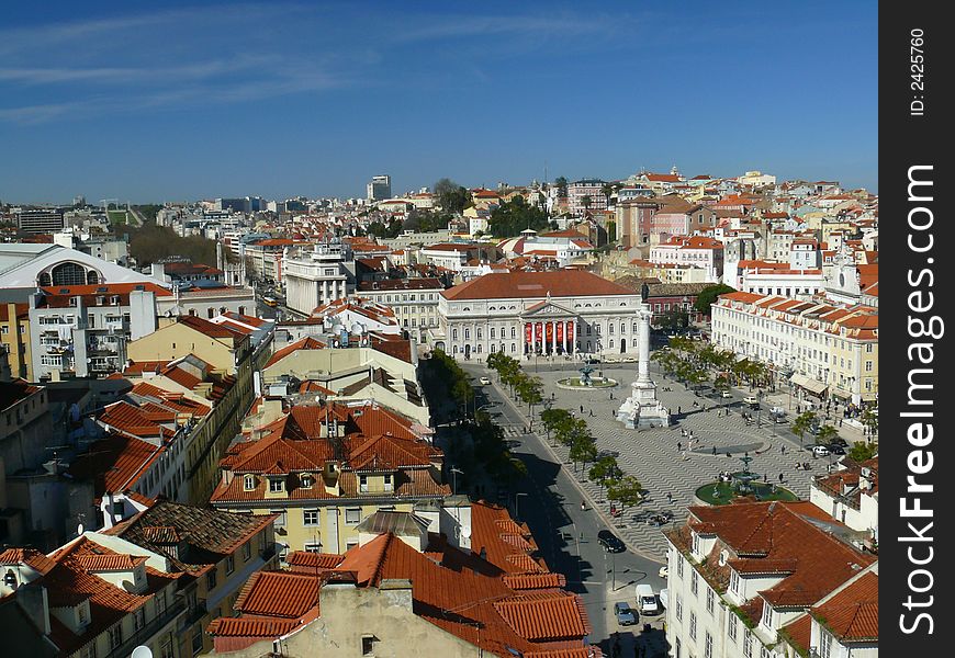 View of downtown Lisbon from Santa Justa's elevator showing the main central square of Rossio with statue of Pedro IV, the National Theater, the Mint House and many other landmark places of the town. View of downtown Lisbon from Santa Justa's elevator showing the main central square of Rossio with statue of Pedro IV, the National Theater, the Mint House and many other landmark places of the town