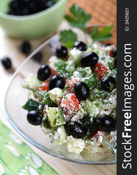 Cottage cheese and vegetables salad in the glass bowl