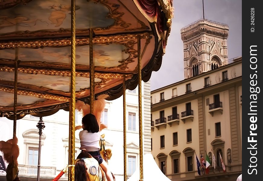 Young girl riding on a merry-go-round in Florence, Italy. Young girl riding on a merry-go-round in Florence, Italy