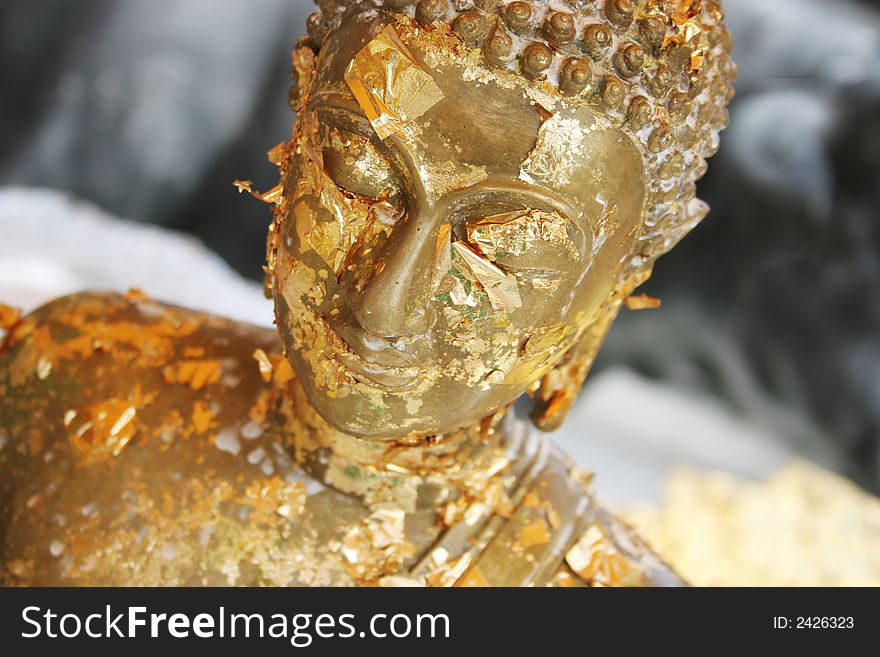 Close-up of a gold Buddhist statue in Thailand - travel and tourism