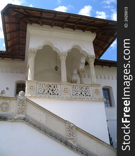 White building with brown tiled roof, brancovenesc style. White building with brown tiled roof, brancovenesc style