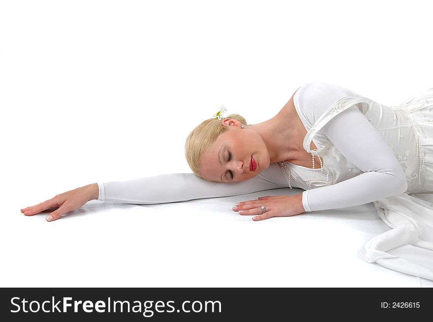 Ballerina resting on her arm on a white background