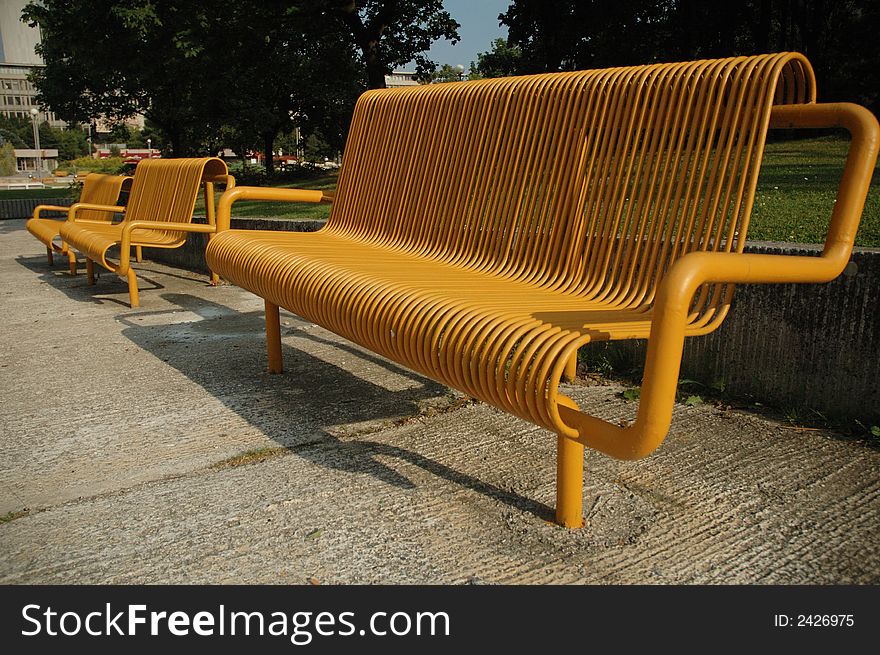 Yellow bench in the city park in Bratislava. Yellow bench in the city park in Bratislava