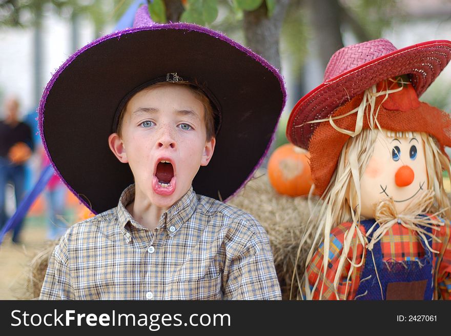 Boy in front of a scarecrow in autumn. Boy in front of a scarecrow in autumn