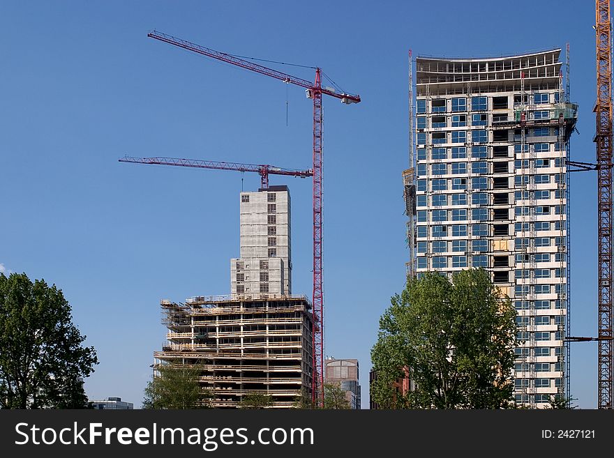 Two office buildings under construction

<a href=http://www.dreamstime.com/search.php?srh_field=building&s_ph=y&s_il=y&s_sm=all&s_cf=1&s_st=wpo&s_catid=&s_cliid=301111&s_colid=&memorize_search=0&s_exc=&s_sp=&s_sl1=y&s_sl2=y&s_sl3=y&s_sl4=y&s_sl5=y&s_rsf=0&s_rst=7&s_clc=y&s_clm=y&s_orp=y&s_ors=y&s_orl=y&s_orw=y&x=32&y=17> See more buildings</a>