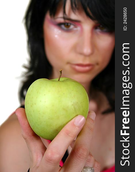 Young girl with green apple, isolated on white, focus in the apple. Young girl with green apple, isolated on white, focus in the apple