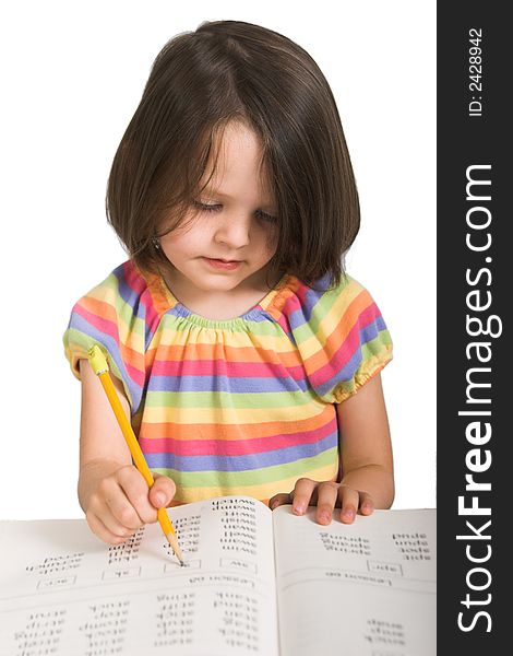 Elementary school girl studying from book, isolated over white