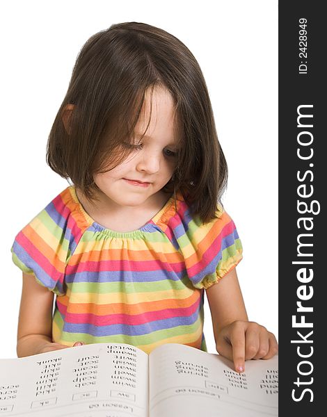 Elementary school girl studying from book, isolated over white