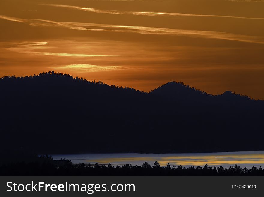 Golden Orange Sunset Reflecting On Lake