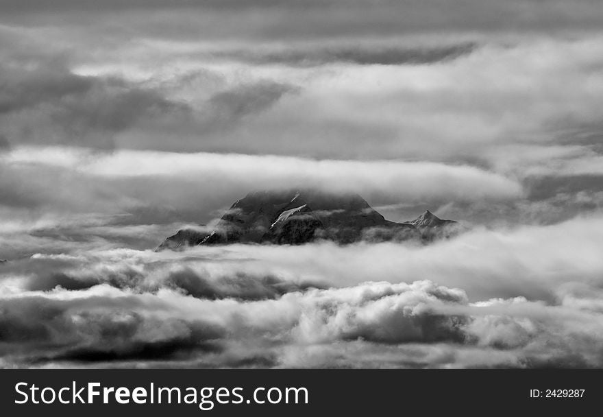 Strong black and white image of Mount Cook through clouds. Strong black and white image of Mount Cook through clouds