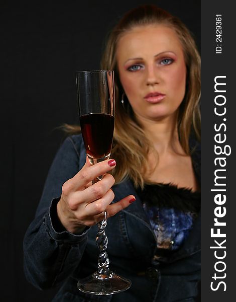 Fashion model drinking, isolated on black background