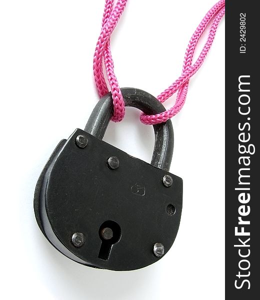 The old black door padlock with pink string. The old black door padlock with pink string