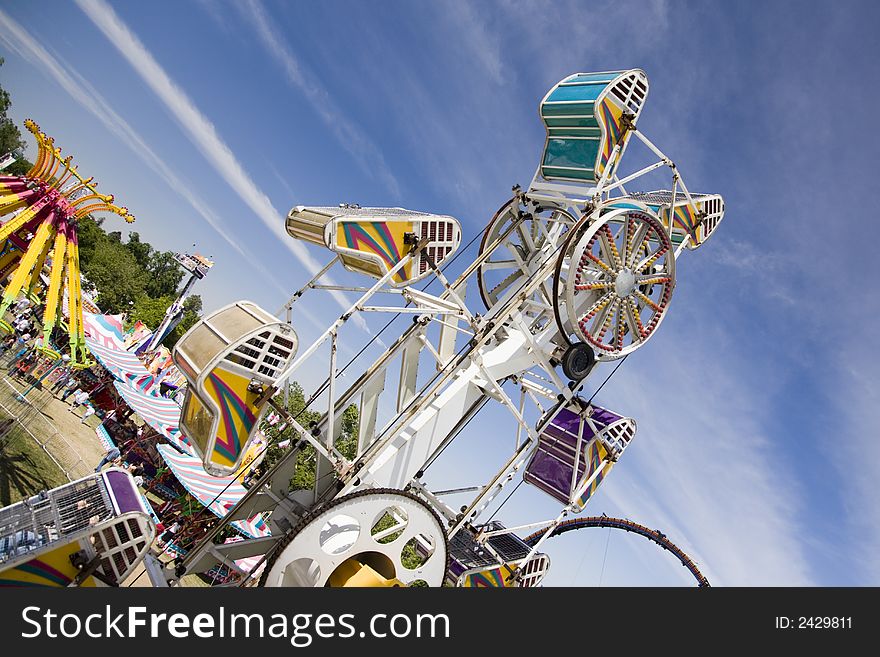 Carnival ride with rotating, spinning chairs