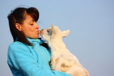 Woman Kissing A Baby Goat Royalty Free Stock Photo