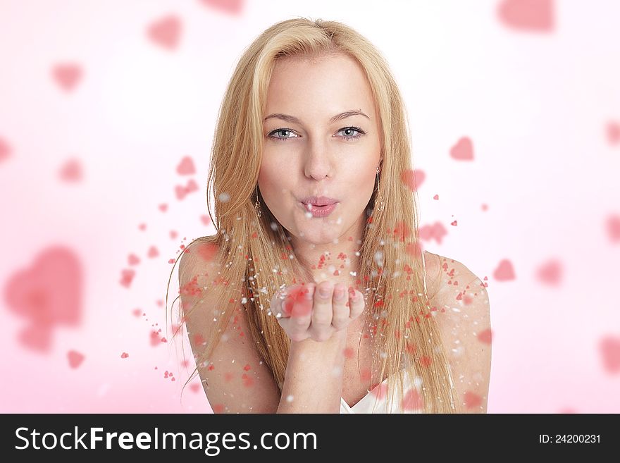 Young blond woman blowing hearts. Young blond woman blowing hearts