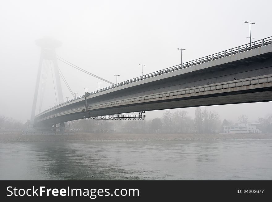 SNP Bridge (also known as New Bridge) covered in fog, Bratislava, Slovakia.