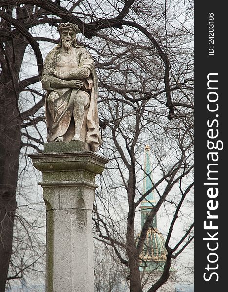 Ancient statue on a pillar, tower of St Martin Cathedral in background. photo in Bratislava Castle park, Slovakia. Ancient statue on a pillar, tower of St Martin Cathedral in background. photo in Bratislava Castle park, Slovakia.