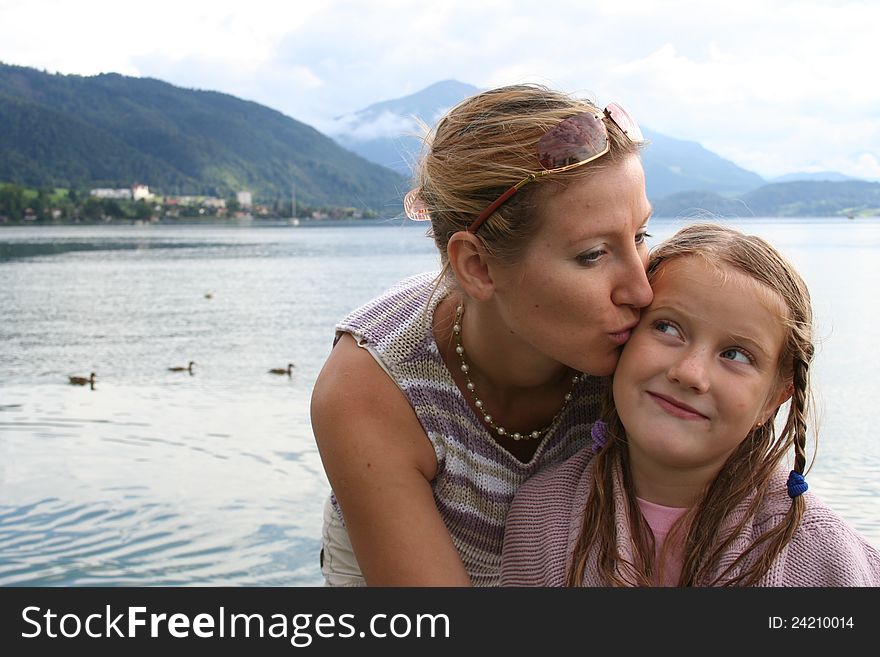 Beauty young mother kiss her daughter. Beauty young mother kiss her daughter