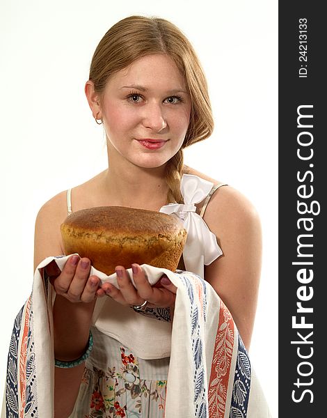 A young girl with fresh bread in the hands of