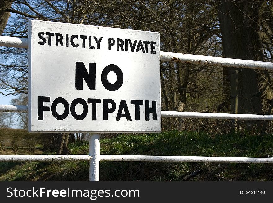 Strictly No Entry sign. White metal gate at entrance to private farmland. Strictly No Entry sign. White metal gate at entrance to private farmland.