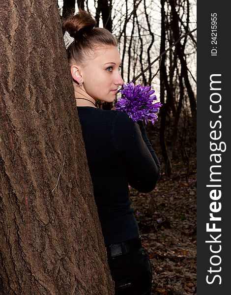 Beautiful girl with snowdrops in a forest