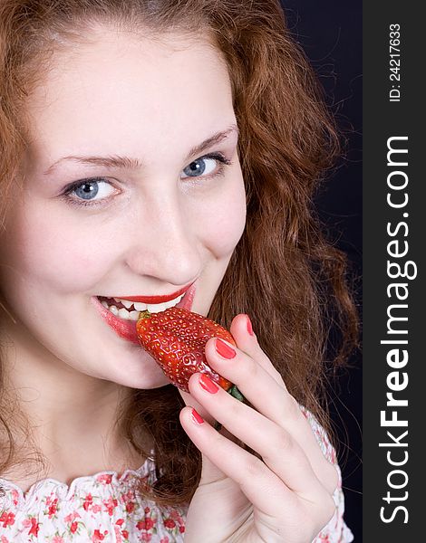 Beautiful girl eating strawberry.