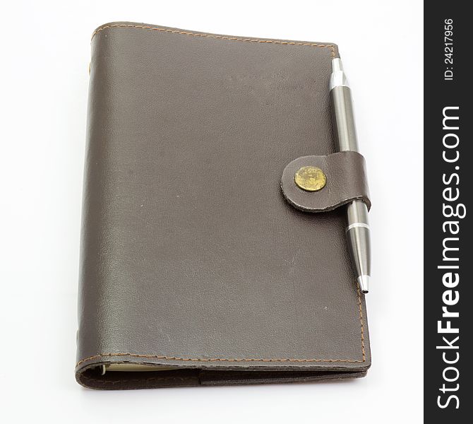Notebook leather cover and pen on isolated background. Notebook leather cover and pen on isolated background