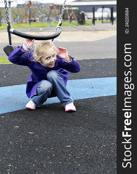 Young girl getting out of the swing. Young girl getting out of the swing