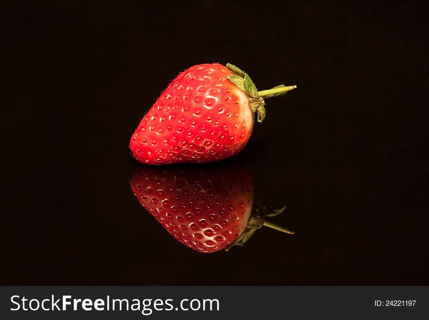 Strawberry isolated on black background.