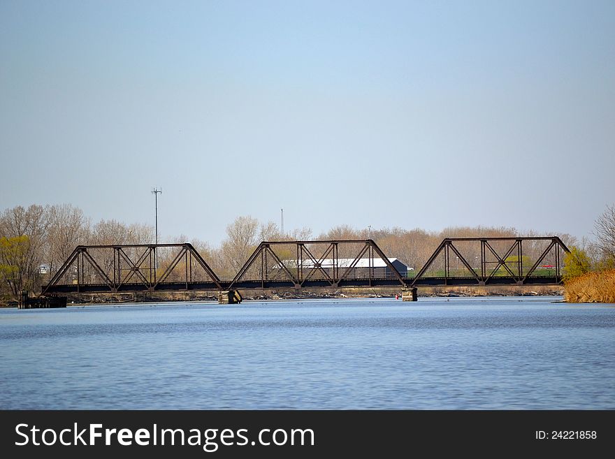 A view of the river near a train bridge