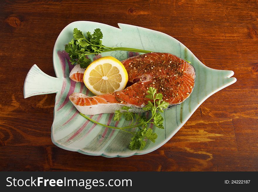 Fresh Pacific Salmon steak with herbs and spices on a plate