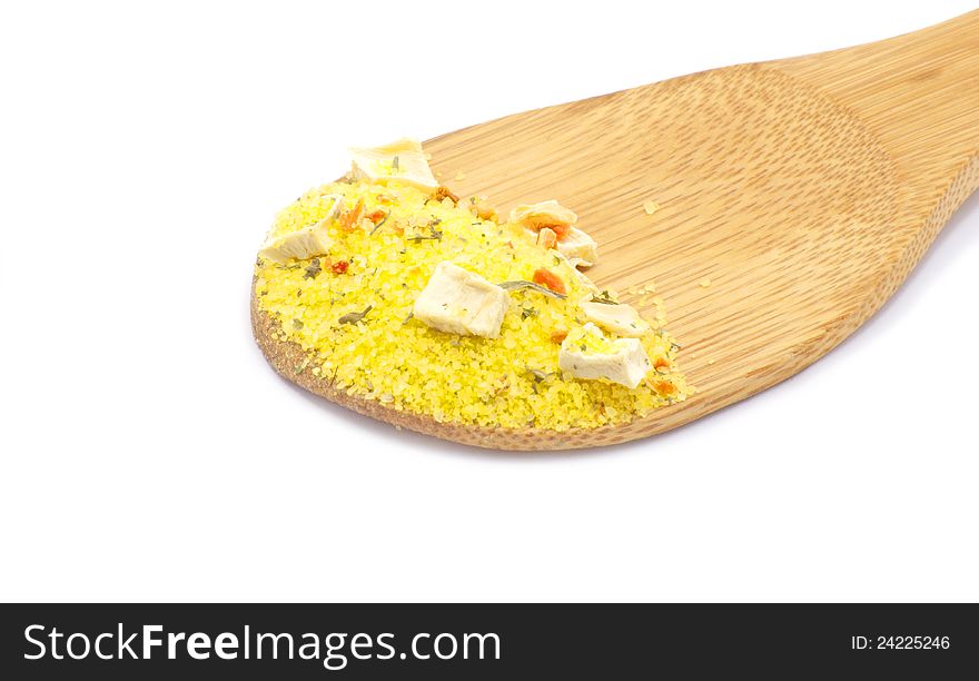 Spices on a wood spoon on white background