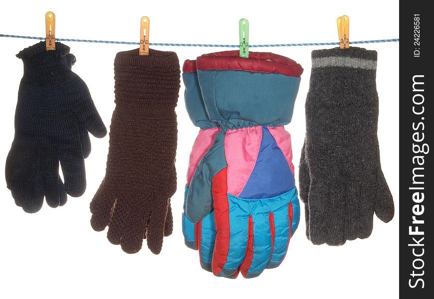 A variety of gloves hanging on a rope, isolated on a white background.