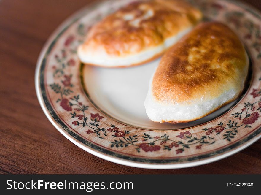 Two pie with meat on a plate closeup