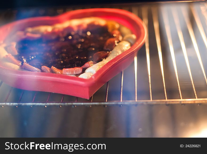 Pieces of jam strawberry pie baking inside the oven